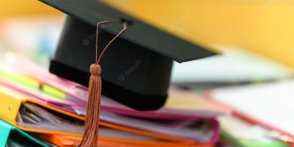 black-graduation-cap-placed-file-folder-desk_43157-2134